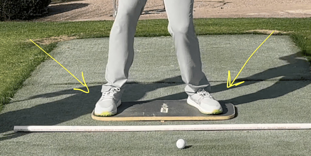 Milo Lines Golf assistant coach, Henry Fall demonstrating proper weight shift in golf swing using the Downshift Board training aid.